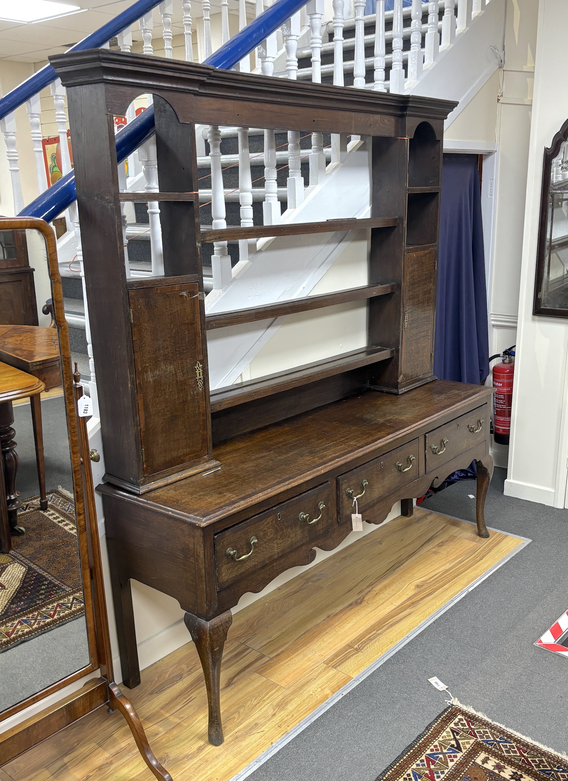 A George III mahogany banded oak dresser, with open rack, width 182cm, depth 48cm, height 195cm